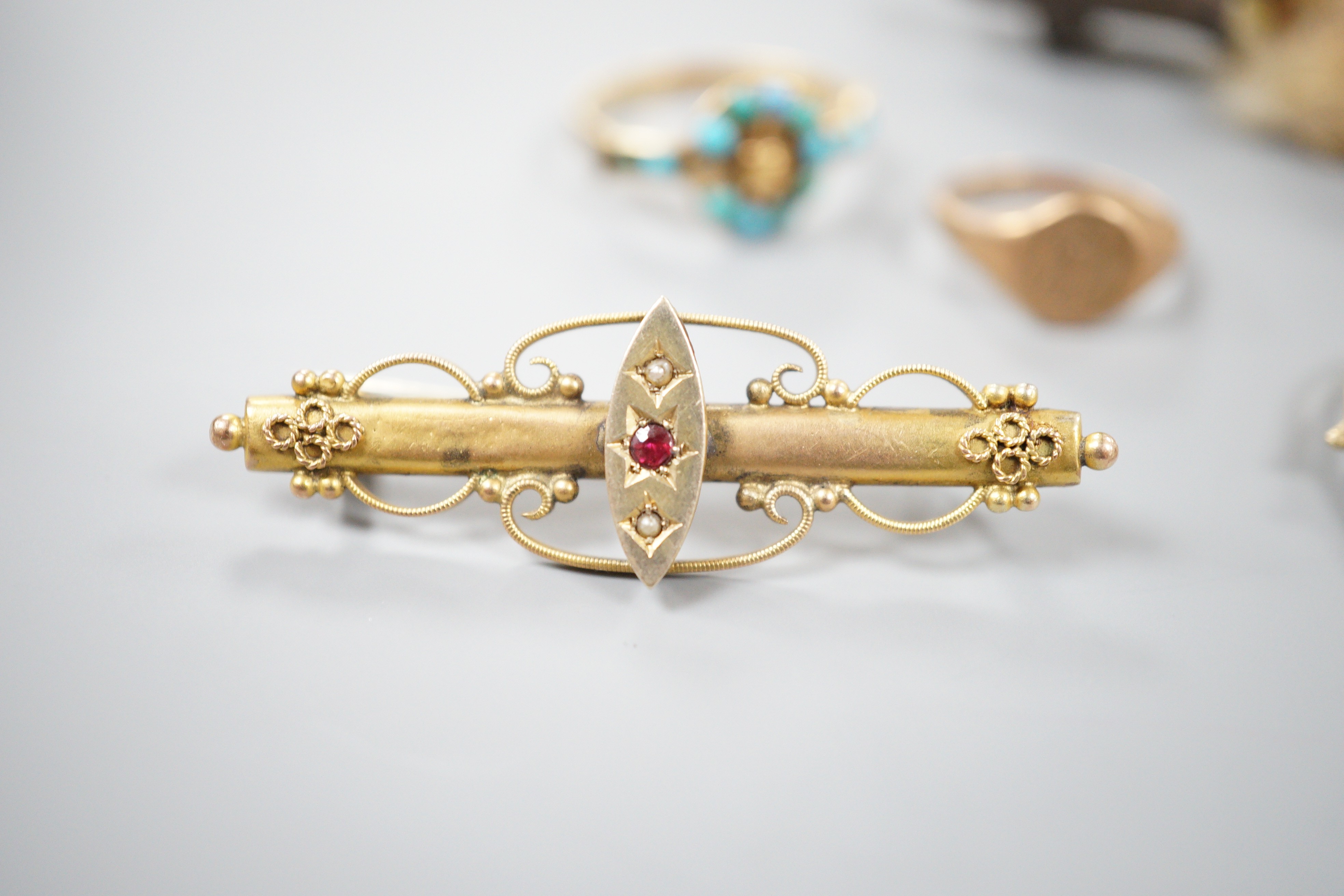 A small collection of jewellery to include an Edwardian amethyst and seed pearl pendant, two rings including Victorian yellow metal and turquoise 'buckle' ring, a bar brooch and a paw brooch.